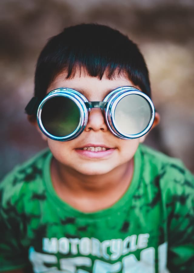 child wearing pilot goggles