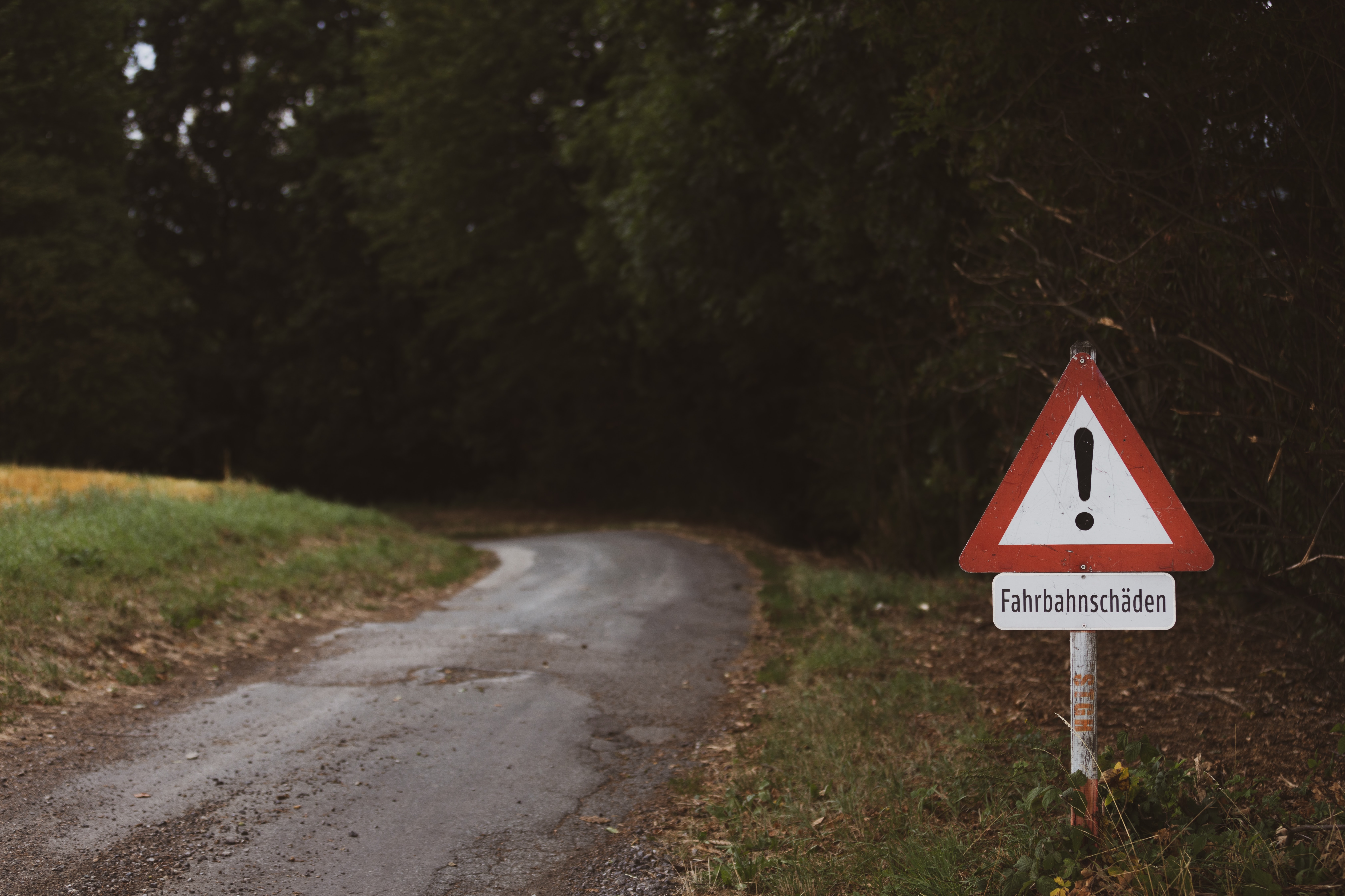 warning sign on the side of road