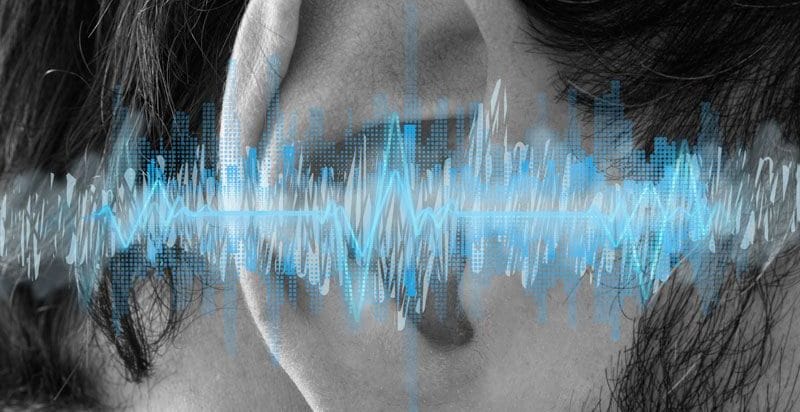 Sound waves illustrated over someone's ear