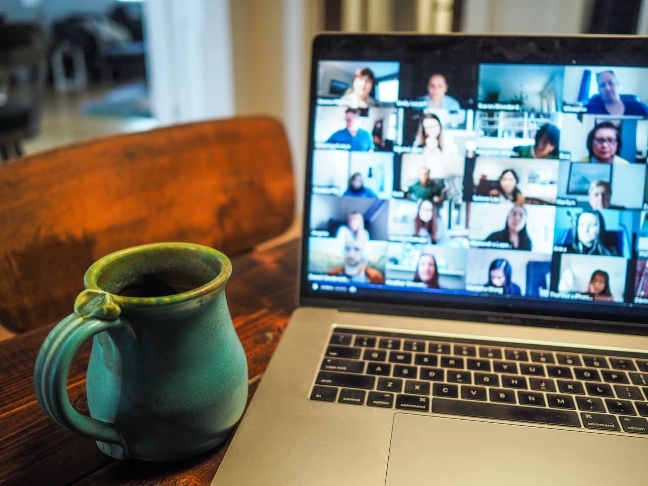 view of a laptop with a meeting and multiple people on the screen