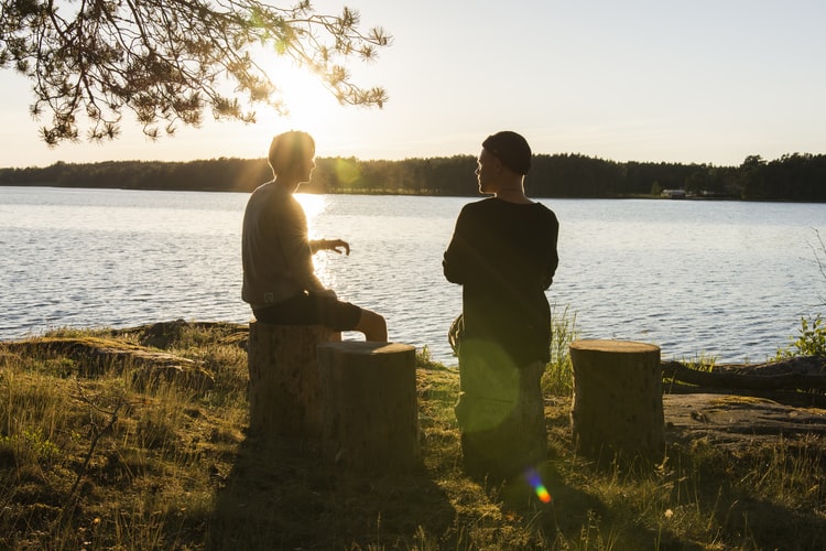 Two people having a conversation outside.