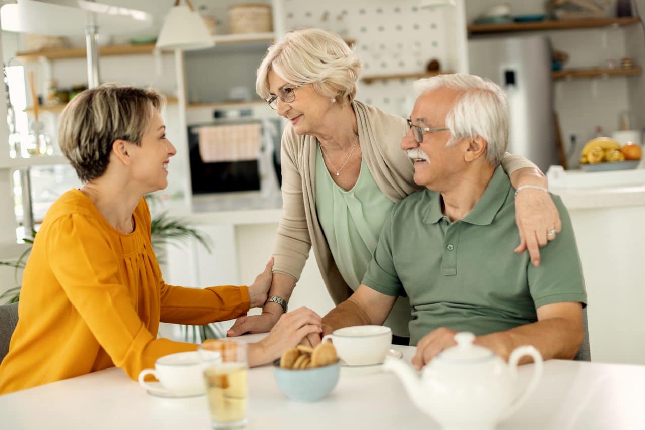 Adult daughter talking with her parents about family genetics.