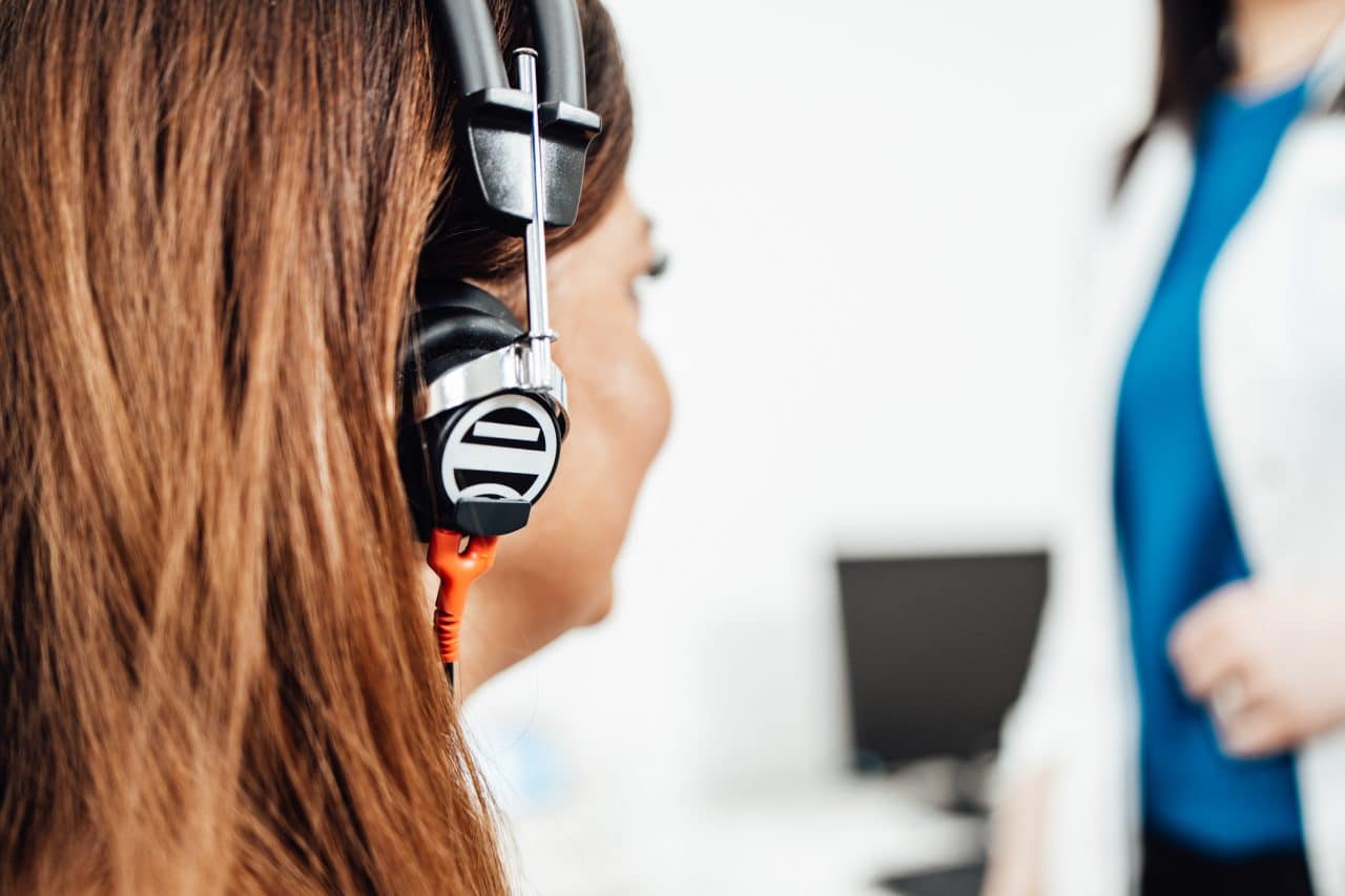 Woman getting a hearing test at an audiologist clinic.