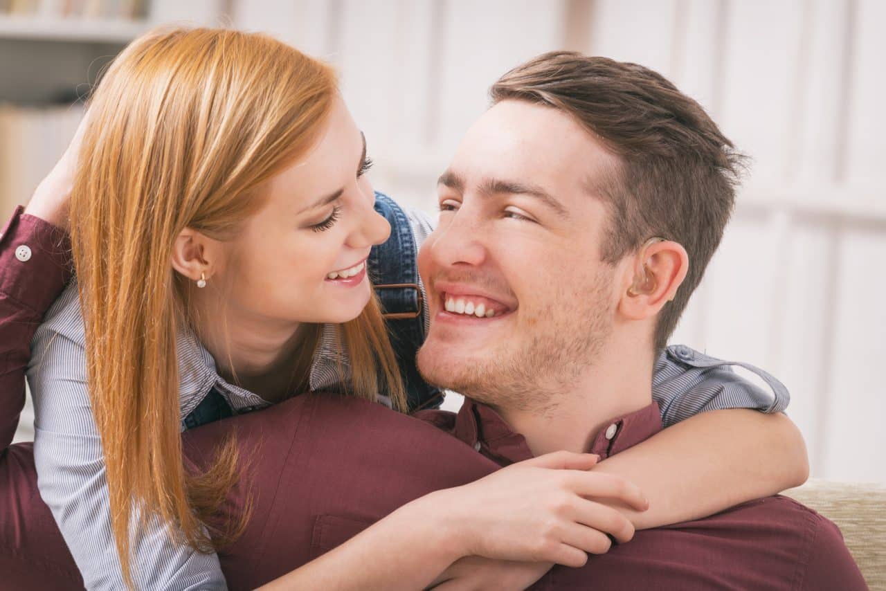 Man wearing hearing aids spending time with his girlfriend.