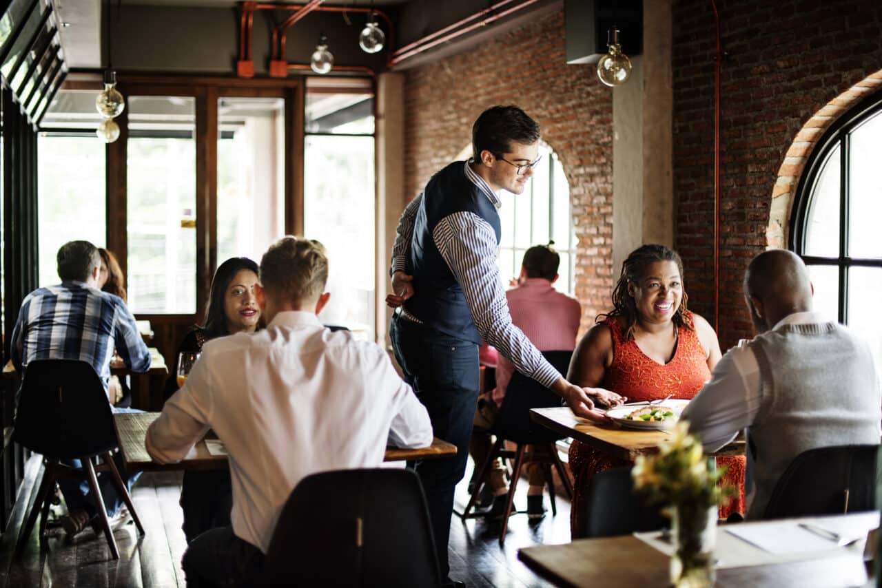 People dining at a busy restaurant.