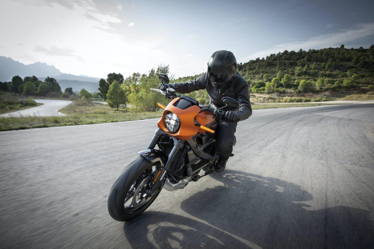 Man riding a motorcycle down an open highway.