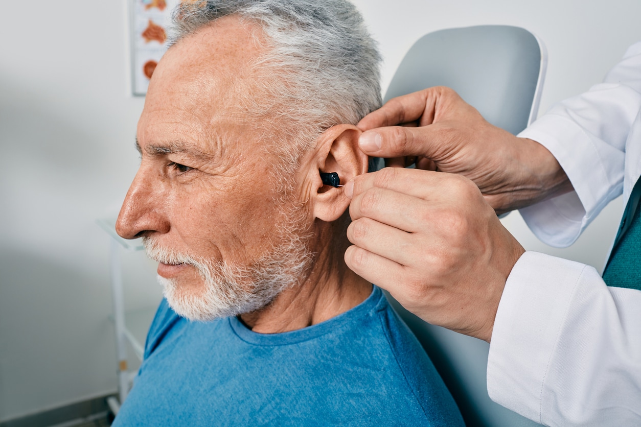 Man being fit for a new hearing aid