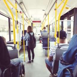 View from behind of people sitting on a public bus.