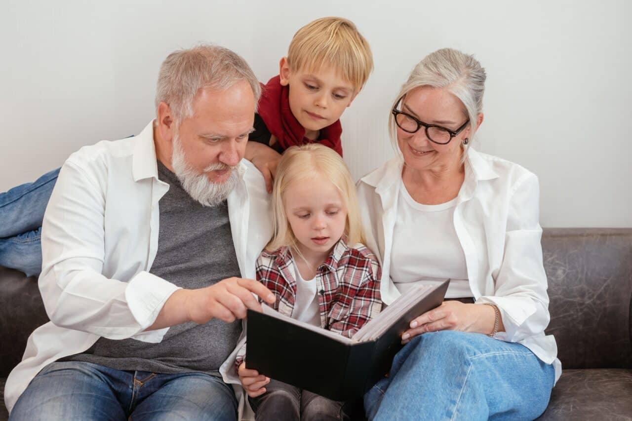 Grandparents reading with their grandchildren.