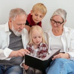 Grandparents reading with their grandchildren.
