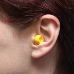 Yellow earplug in ear