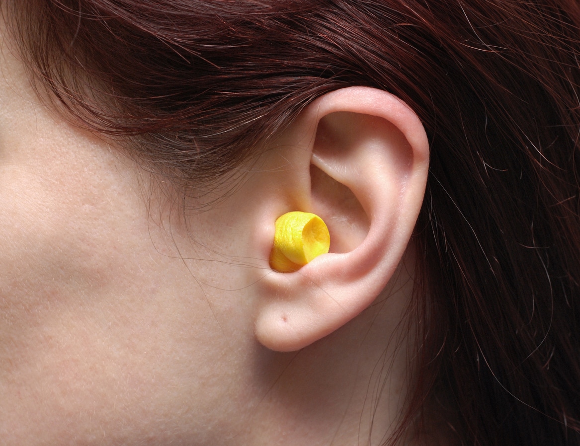 Yellow earplug in ear