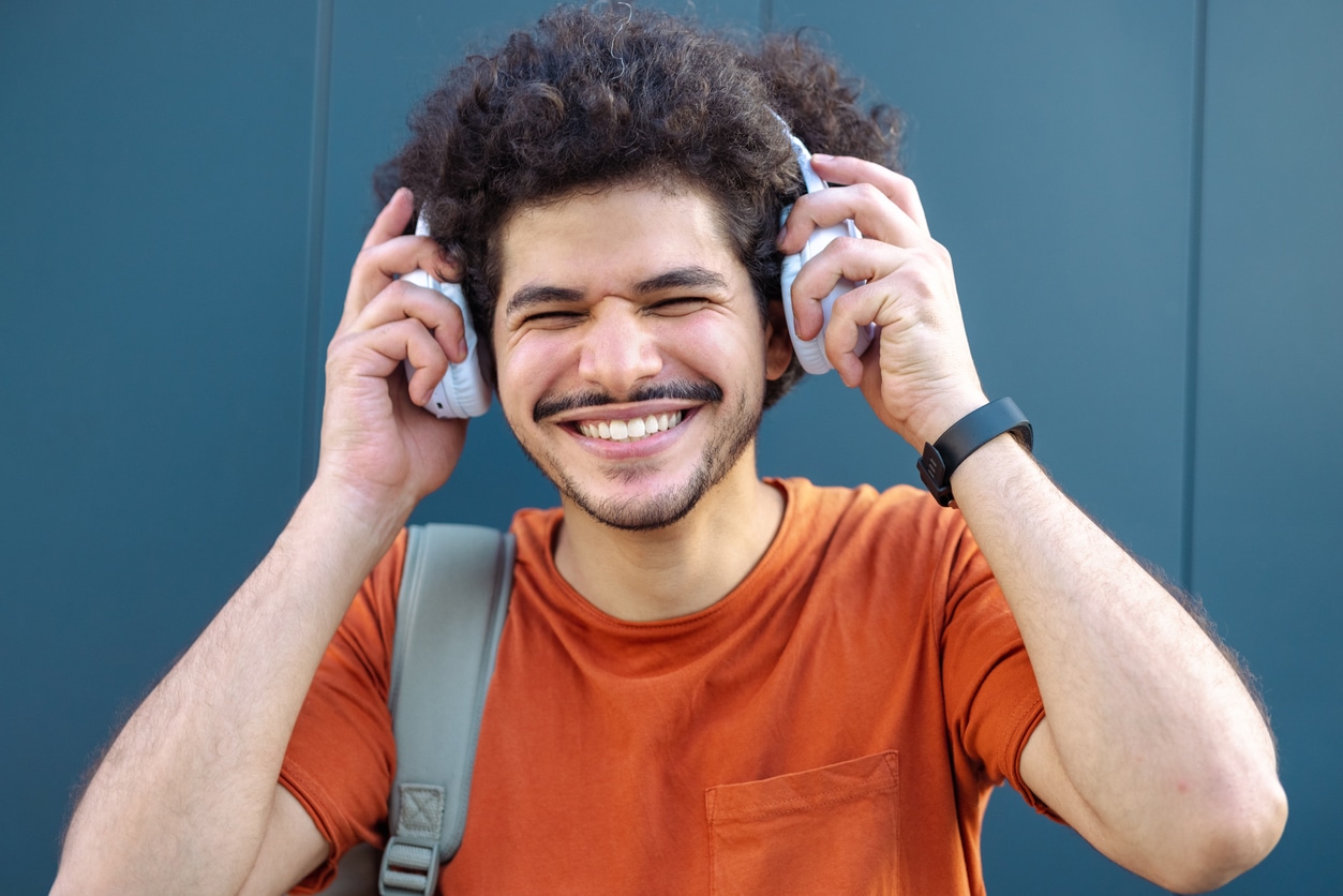 Man putting on noise-cancelling headphones.