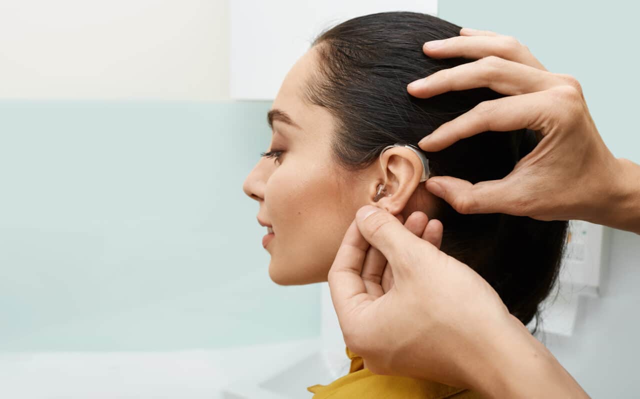 Woman gets fitted for hearing aid