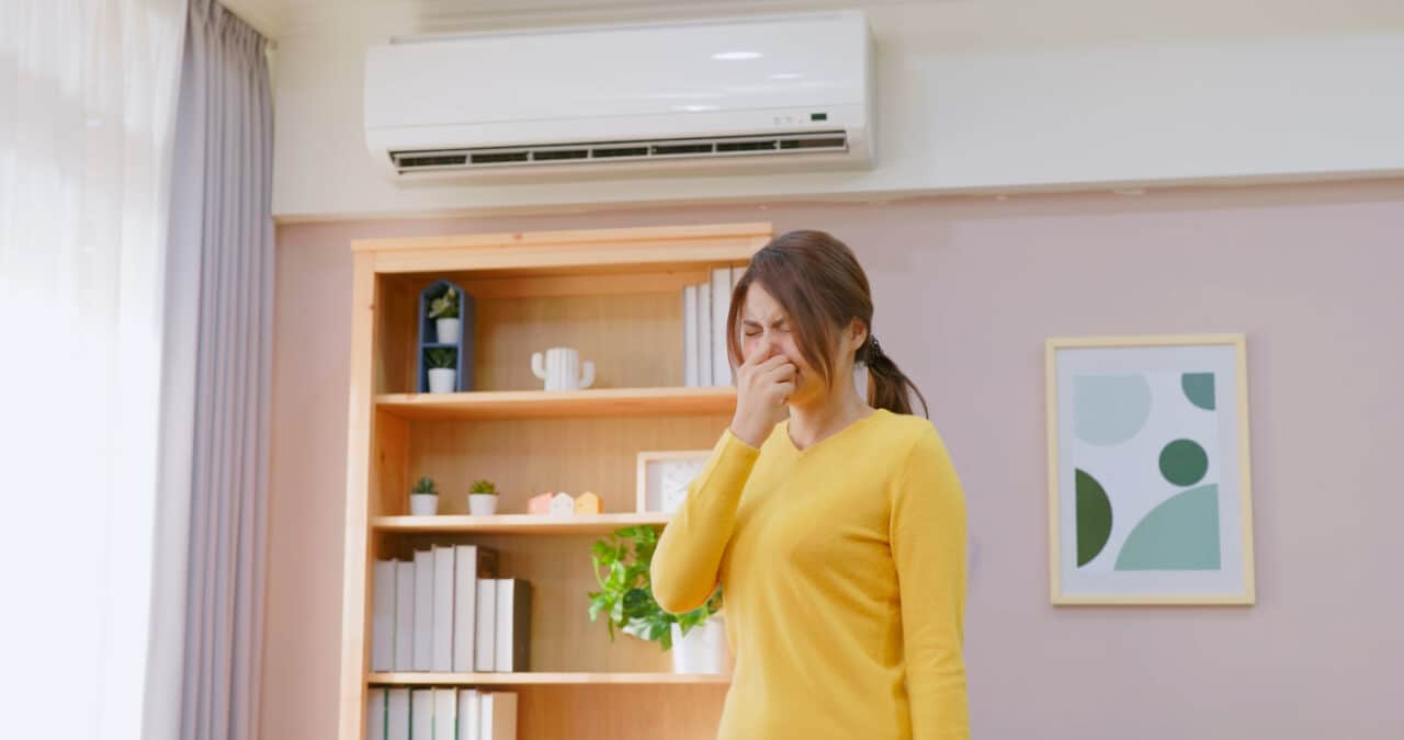 Woman sneezes in room