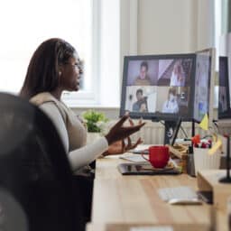 Woman video conferencing from her home office